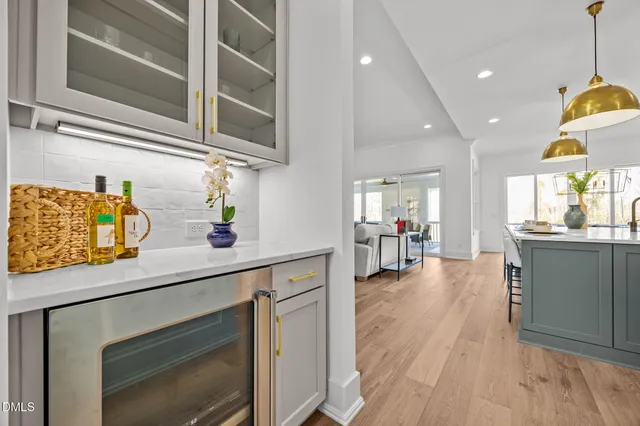 a bedroom with a bed chandelier and a window