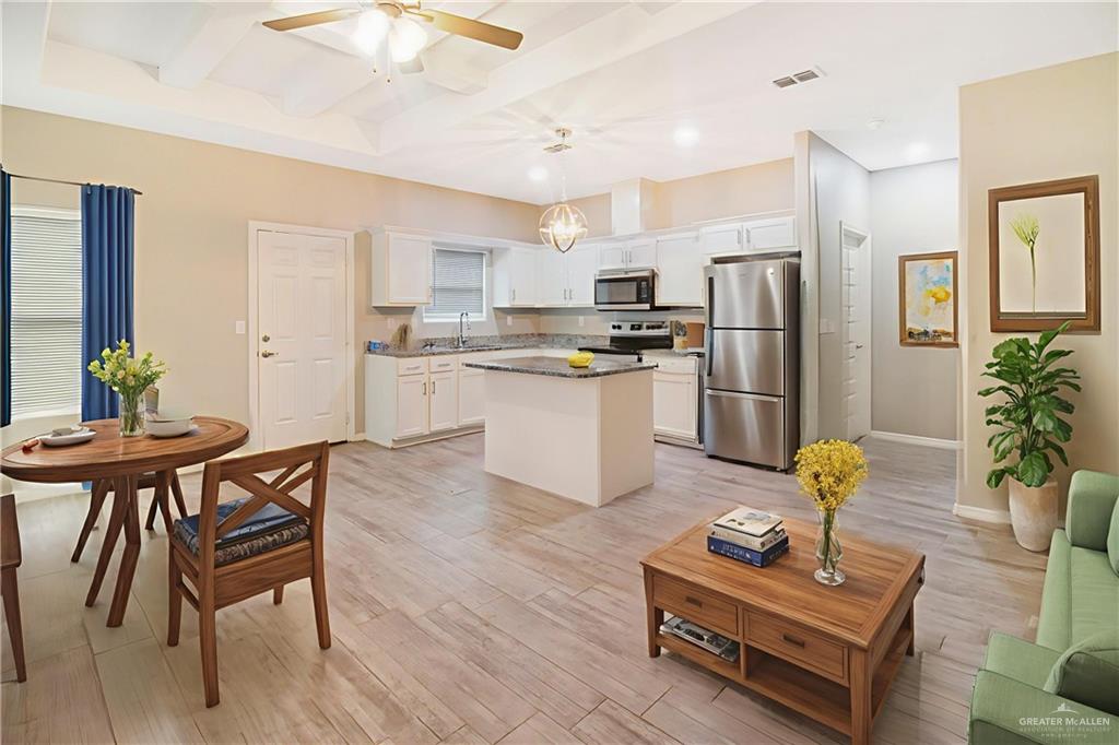 1809 Stauffer Street, Unit 4 Weslaco, TX 78596 - Photo 7 of 13 Kitchen featuring stainless steel appliances, white cabinets, ceiling fan, light stone countertops, and pendant lighting
