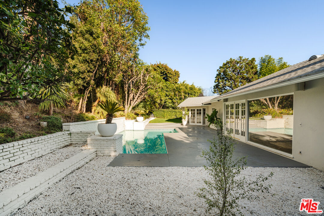 10101 Angelo Circle Beverly Hills, CA 90210 - Photo 4 of 7 a front view of a house with a yard and trees
