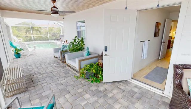 a living room with furniture and floor to ceiling windows