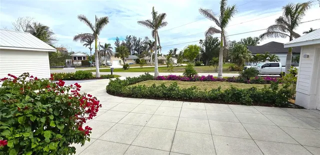 a living room with furniture kitchen view and a chandelier