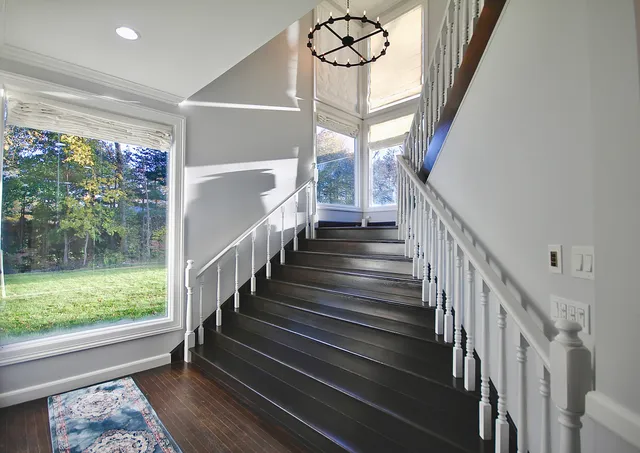 a view of entryway with wooden floor and stairs