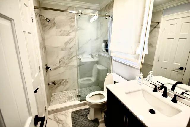 a bathroom with a sink toilet and shower