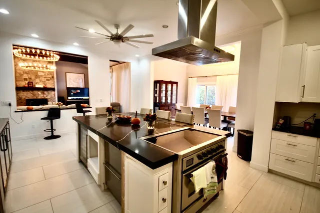 a kitchen with stainless steel appliances a stove a sink and a refrigerator