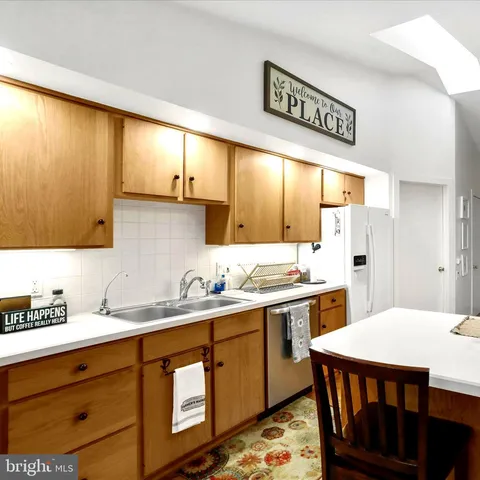 a kitchen with a sink cabinets and wooden floor