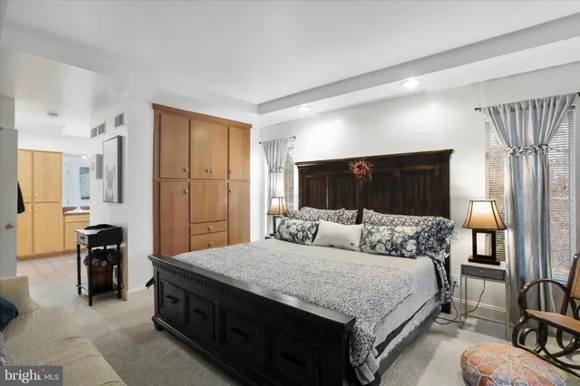 a bedroom with a bed and a view of kitchen