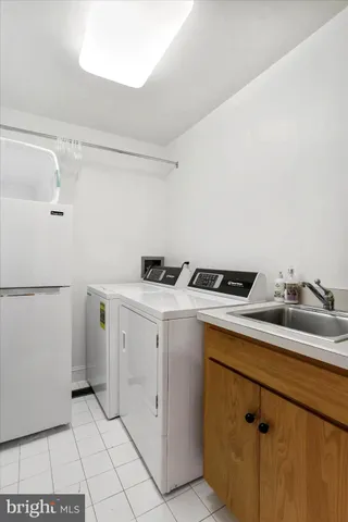 a utility room with cabinets washer and dryer