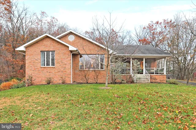 a view of a house with a yard and sitting area
