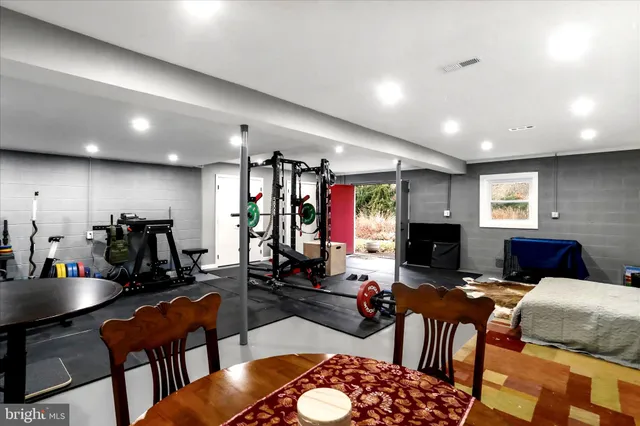 a living room with furniture a dining table and a flat screen tv