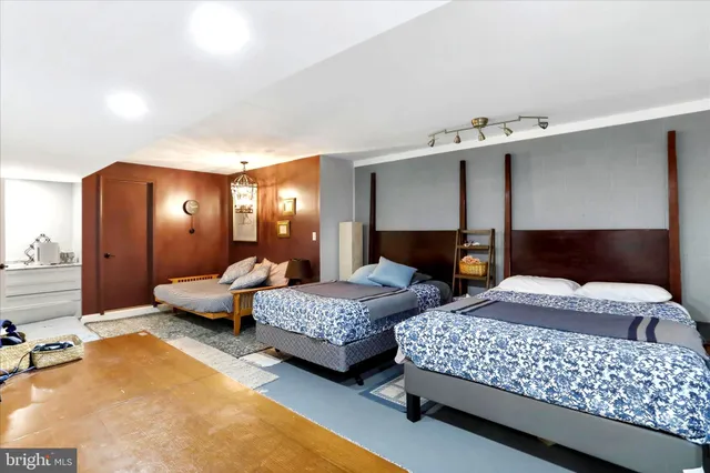 a bedroom with two beds and large windows