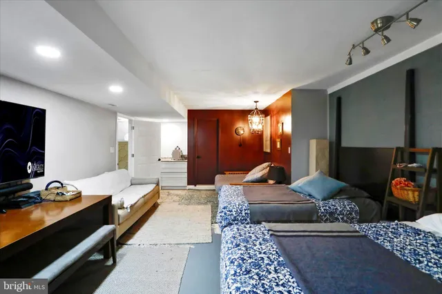 a living room with furniture rug and lamp