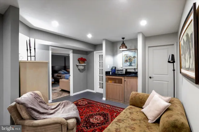a living room with furniture and a kitchen