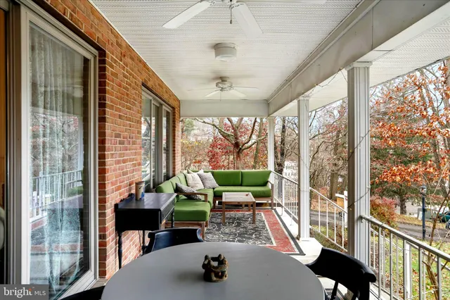 a view of a room with furniture and a large window