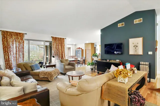 a living room with furniture and a floor to ceiling window