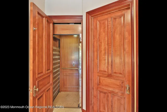 a dining room with furniture a chandelier and window