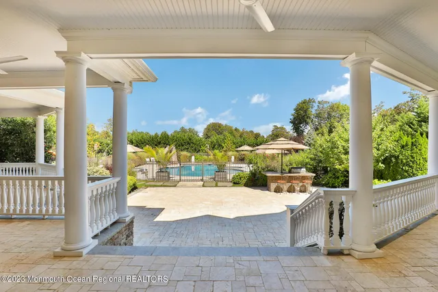 a view of a patio with table and chairs and potted plants
