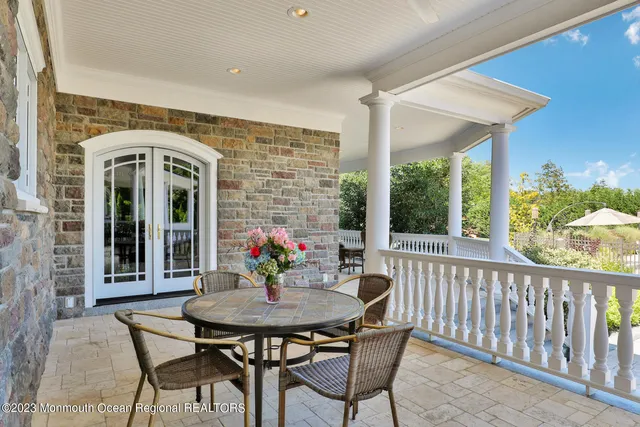 a front view of a house with swimming pool having outdoor seating
