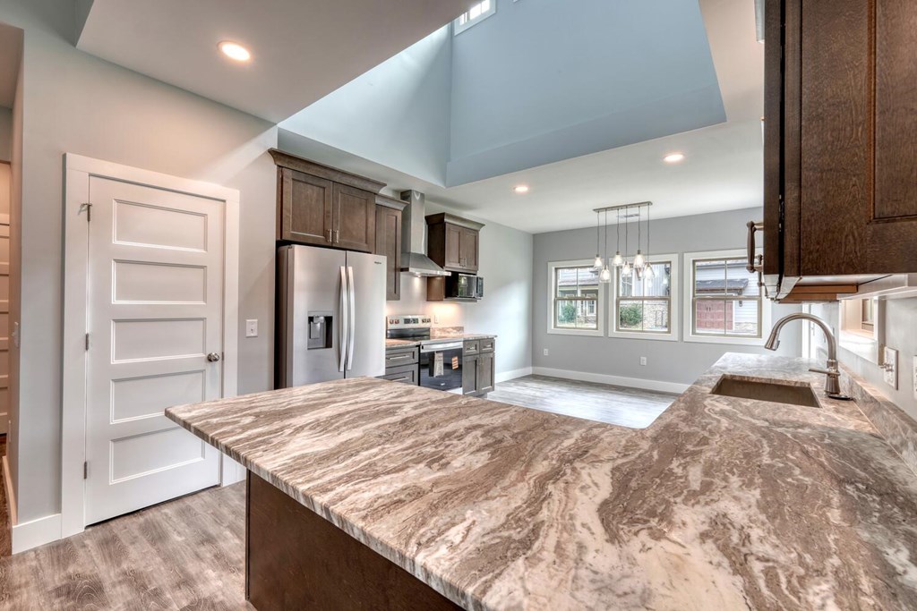 98 Brett Way Hiawassee, GA 30546 - Photo 12 of 39 a kitchen with kitchen island granite countertop a sink stove and refrigerator
