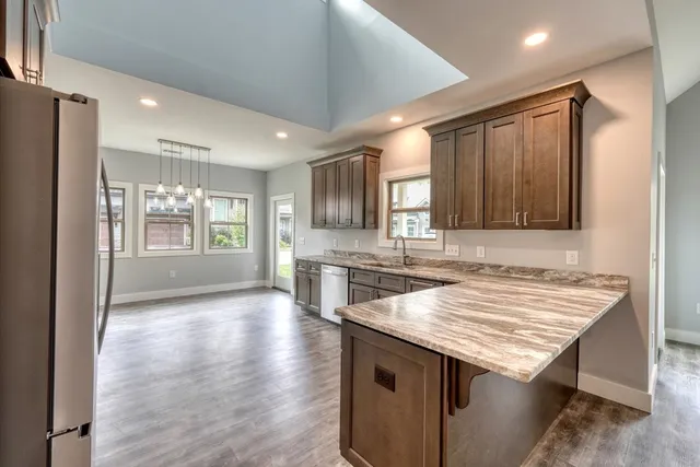 a kitchen with granite countertop a stove and a sink