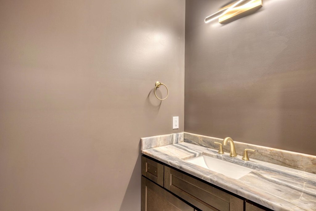 98 Brett Way Hiawassee, GA 30546 - Photo 19 of 39 a bathroom with a granite countertop sink and a mirror