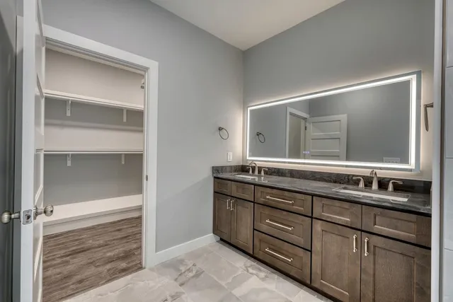a bathroom with a sink vanity and mirror