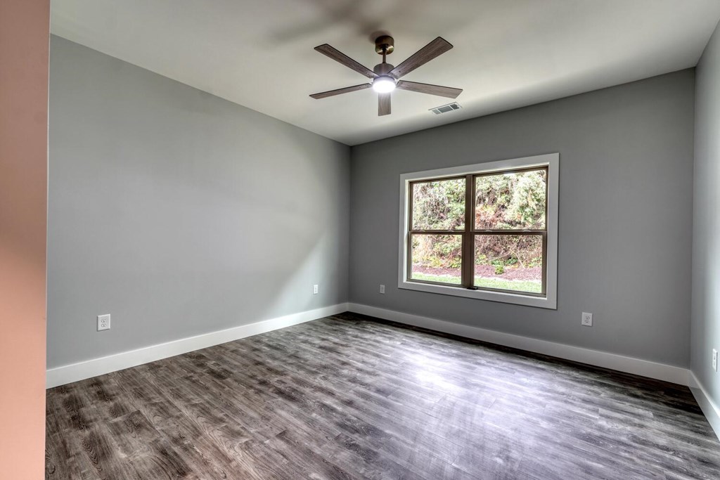 98 Brett Way Hiawassee, GA 30546 - Photo 26 of 39 an empty room with wooden floor and windows
