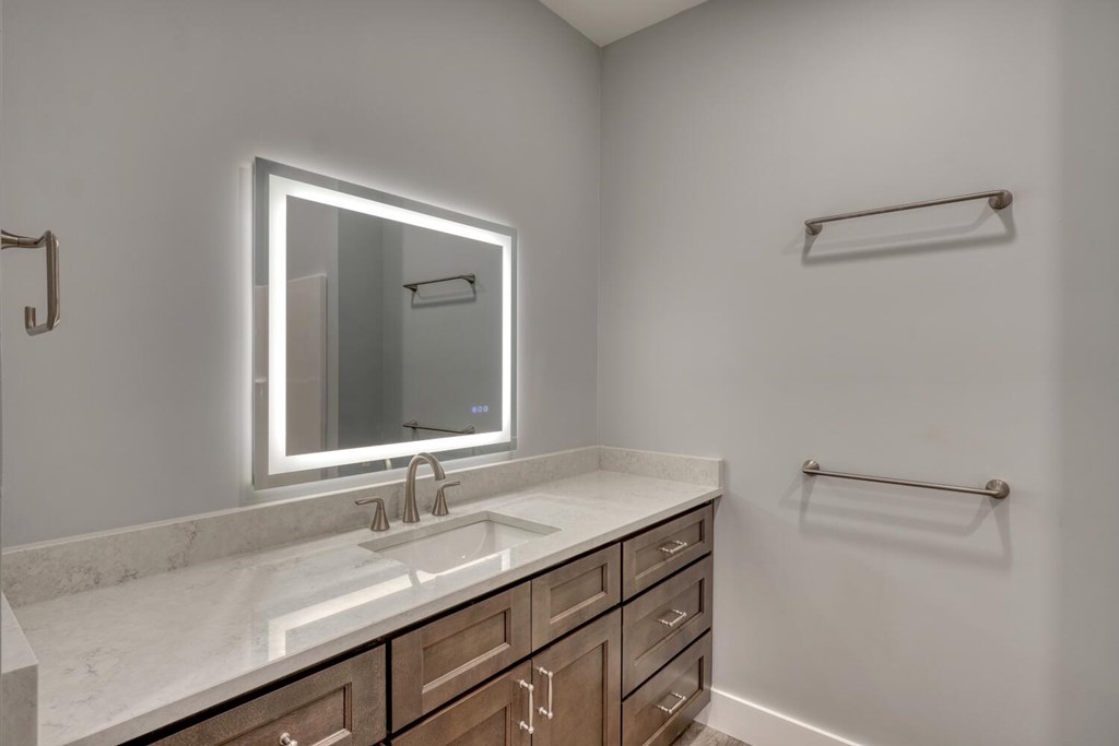 98 Brett Way Hiawassee, GA 30546 - Photo 28 of 39 a bathroom with a granite countertop sink and a mirror