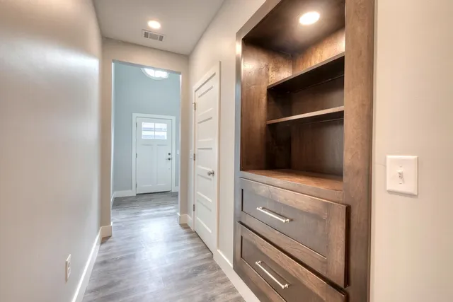 a view of hallway with wooden floor