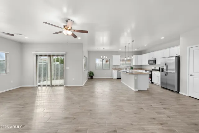 a view of kitchen with stainless steel appliances refrigerator oven and cabinets