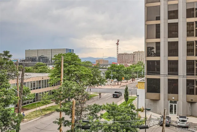 a city street lined with buildings and cars