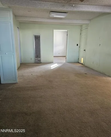 a view of a room with wooden floor and white cabinet
