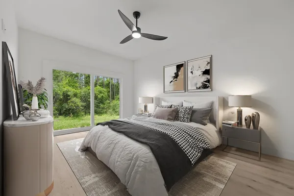 a bedroom with a bed and a large window