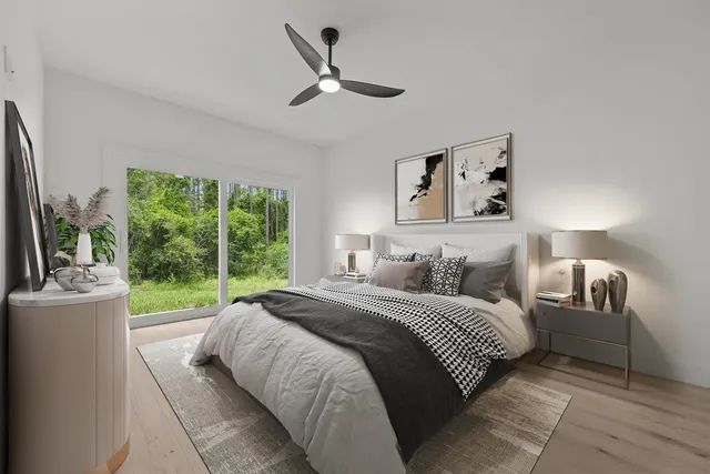 a bedroom with a bed and a large window