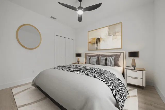 a bedroom with a bed and a chandelier