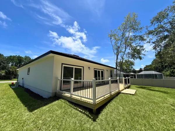 a front view of a house with a yard fire pit and outdoor seating