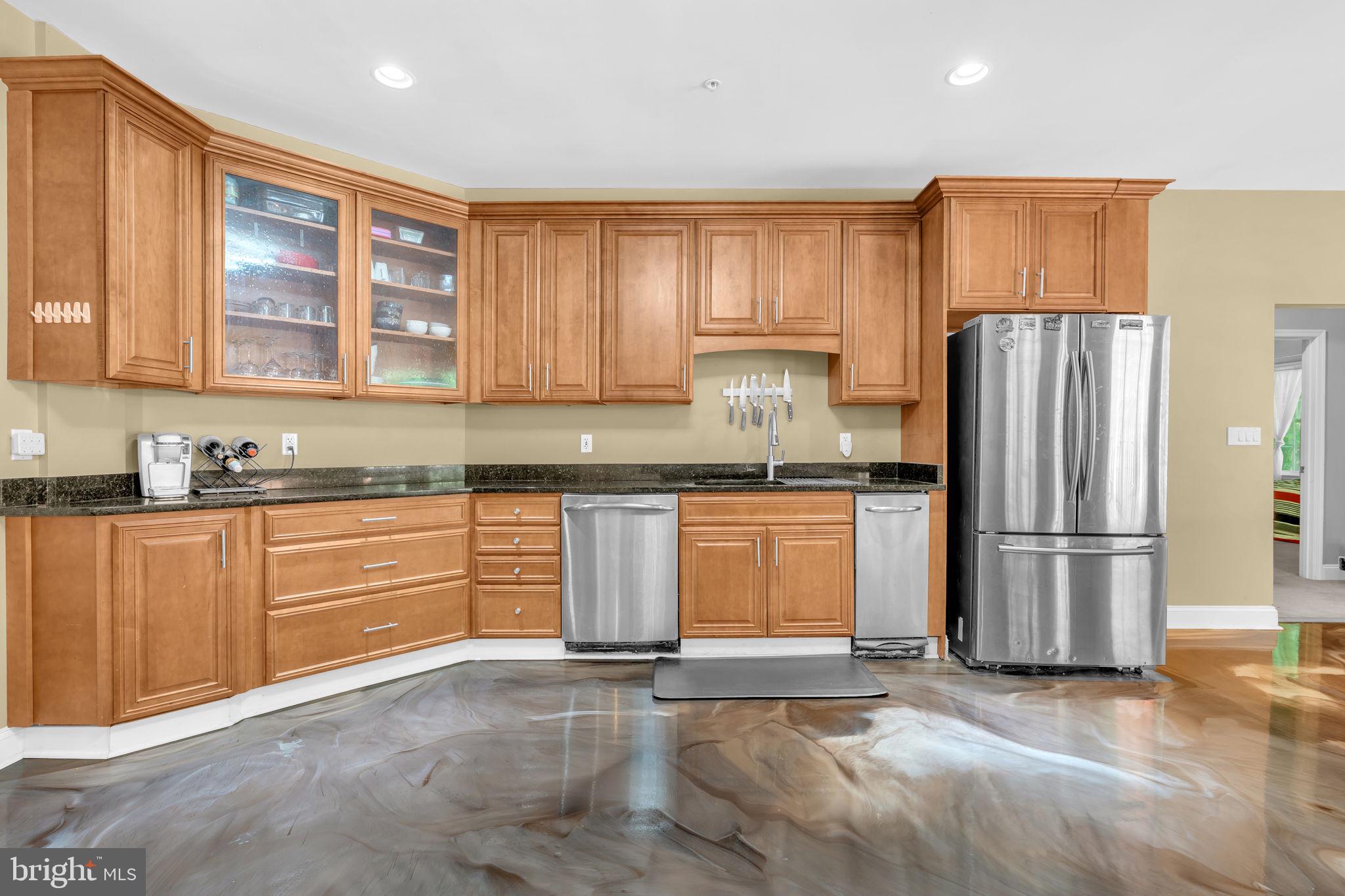 13716 Molly Berry Road Brandywine, MD 20613 - Photo 14 of 75 a kitchen with stainless steel appliances granite countertop a refrigerator sink and cabinets