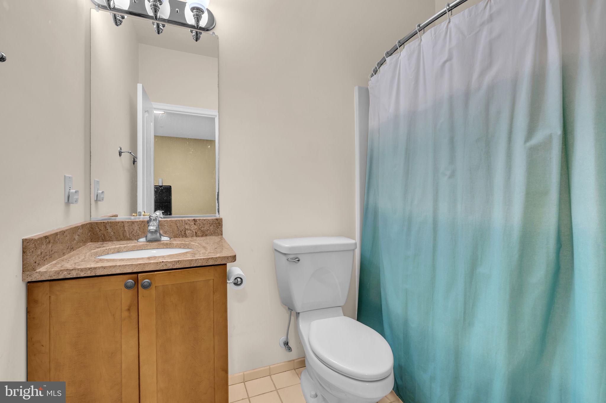 13716 Molly Berry Road Brandywine, MD 20613 - Photo 27 of 75 a bathroom with a granite countertop sink toilet and a mirror