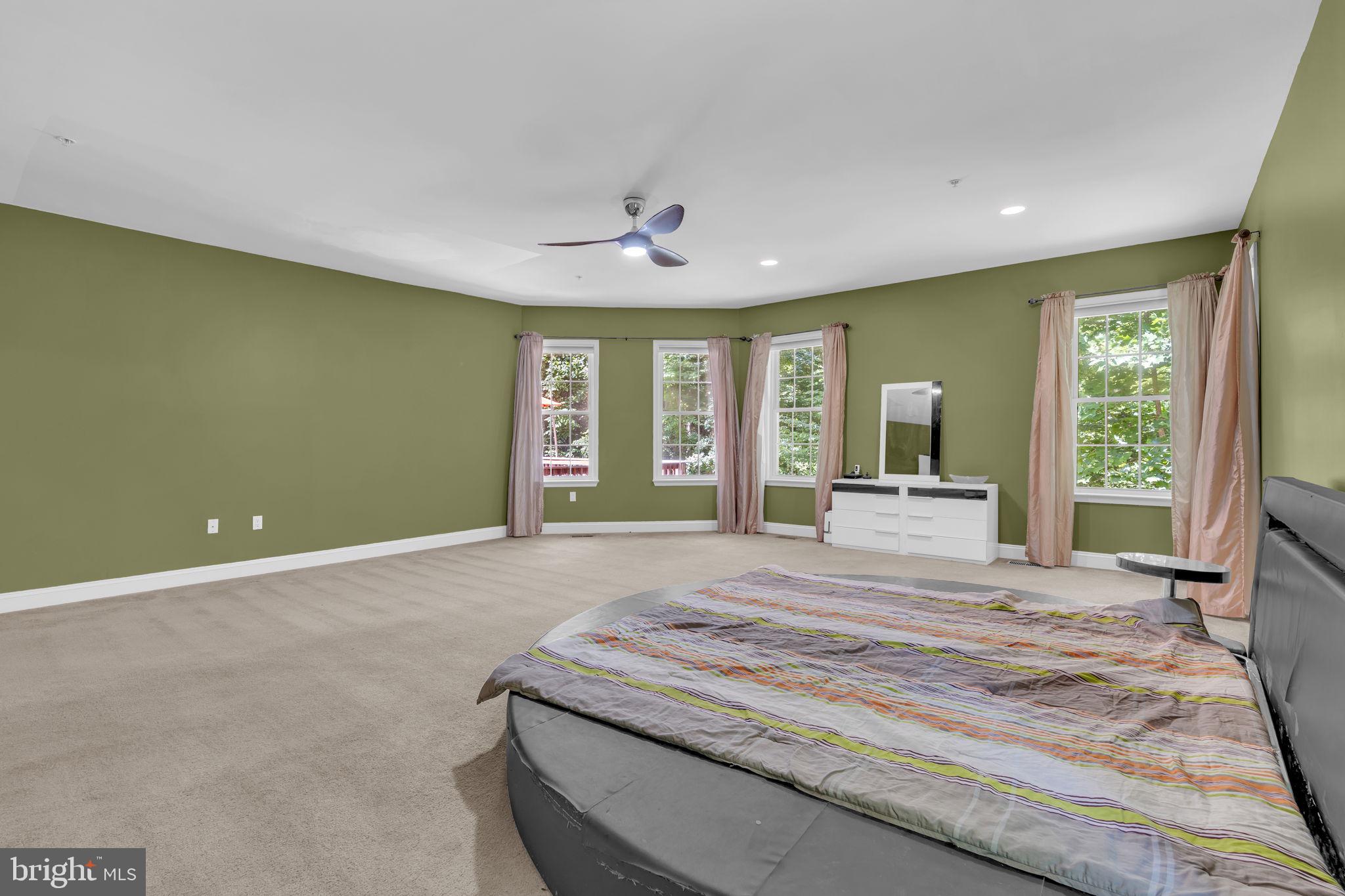 13716 Molly Berry Road Brandywine, MD 20613 - Photo 33 of 75 a spacious bedroom with a bed and a large window