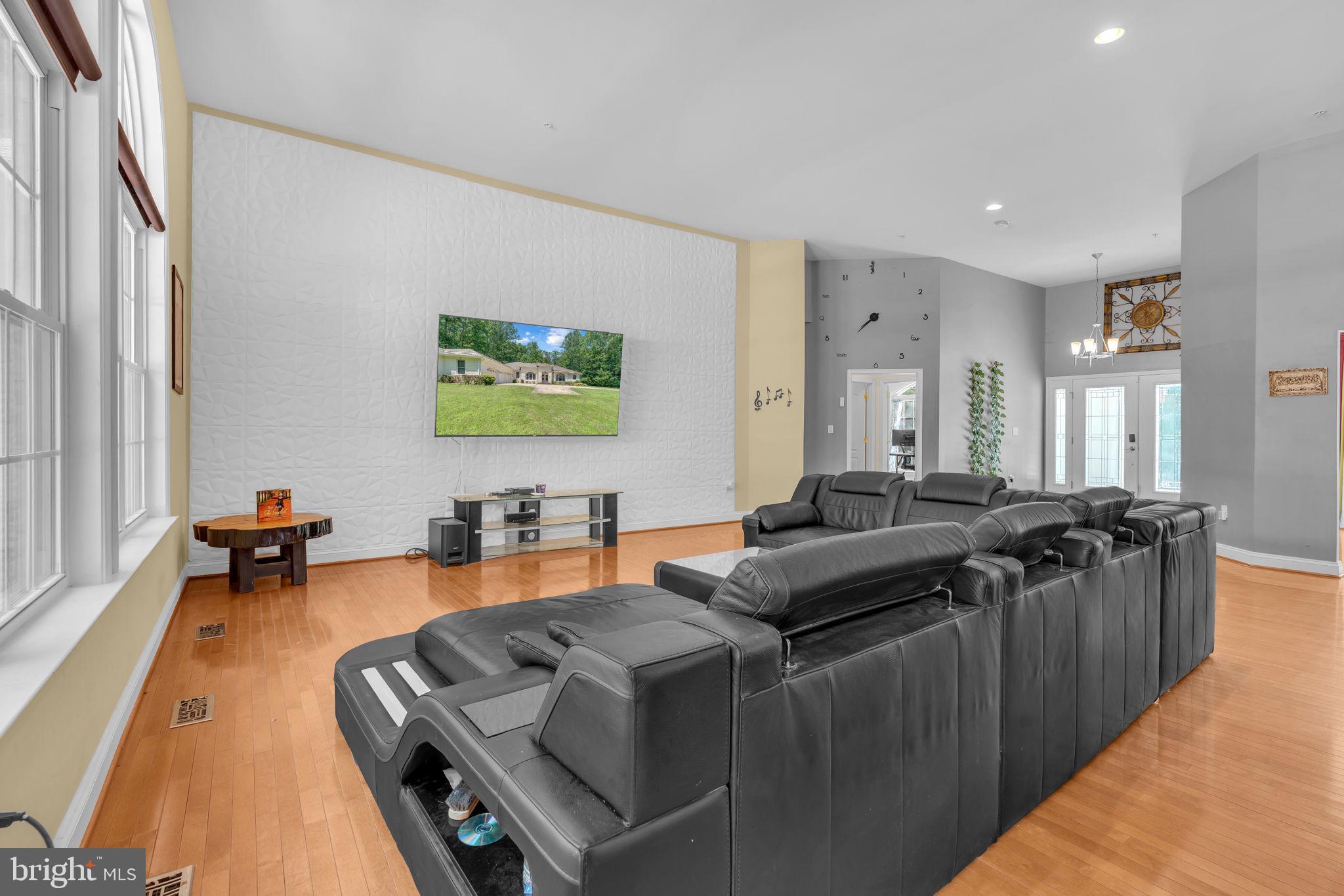 13716 Molly Berry Road Brandywine, MD 20613 - Photo 6 of 75 a living room with furniture and a flat screen tv