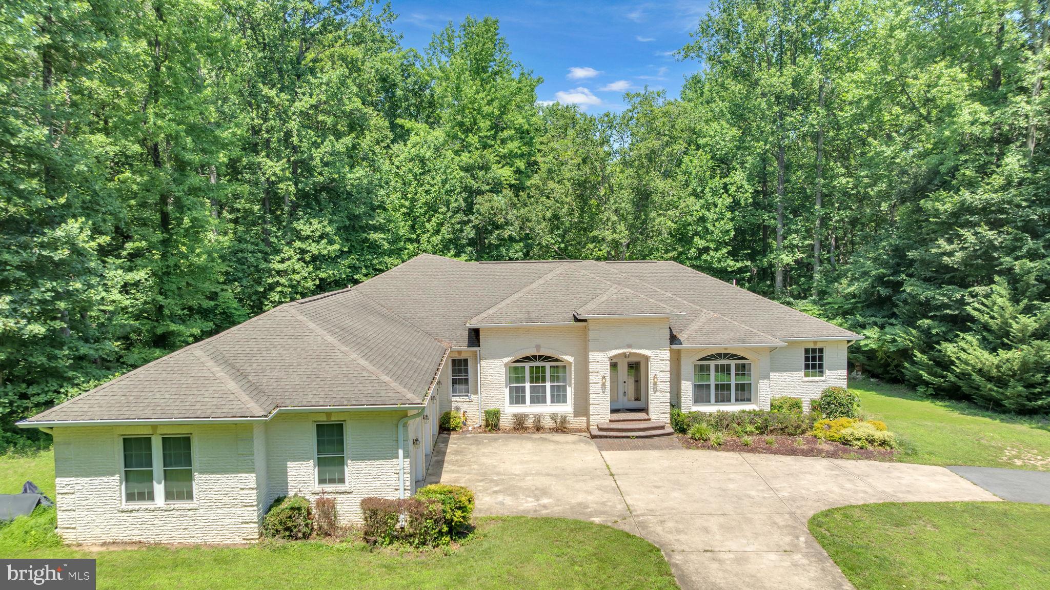 13716 Molly Berry Road Brandywine, MD 20613 - Photo 62 of 75 a view of house with garden and tall trees
