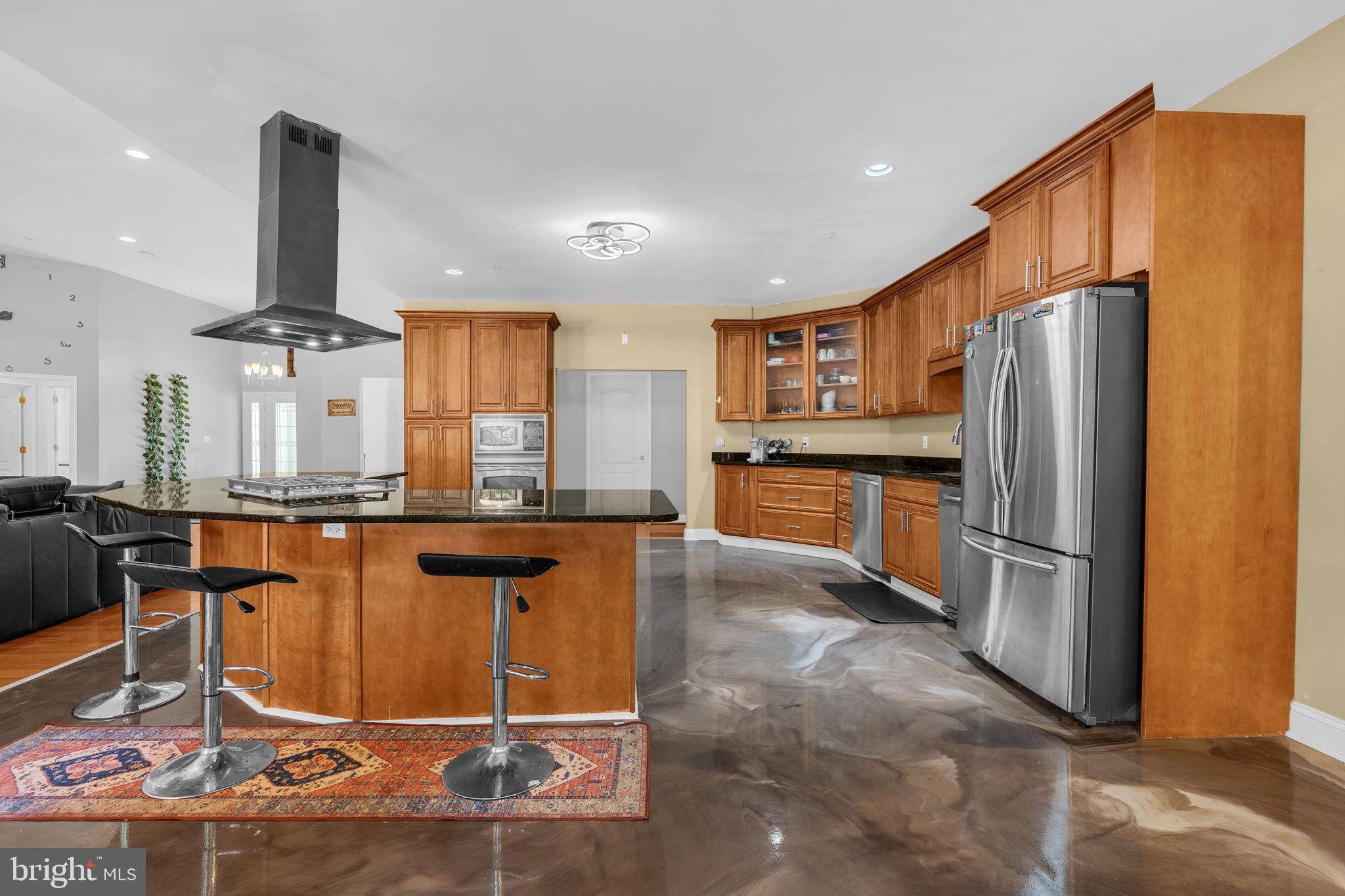 13716 Molly Berry Road Brandywine, MD 20613 - Photo 10 of 75 a kitchen with stainless steel appliances granite countertop a refrigerator and a stove top oven