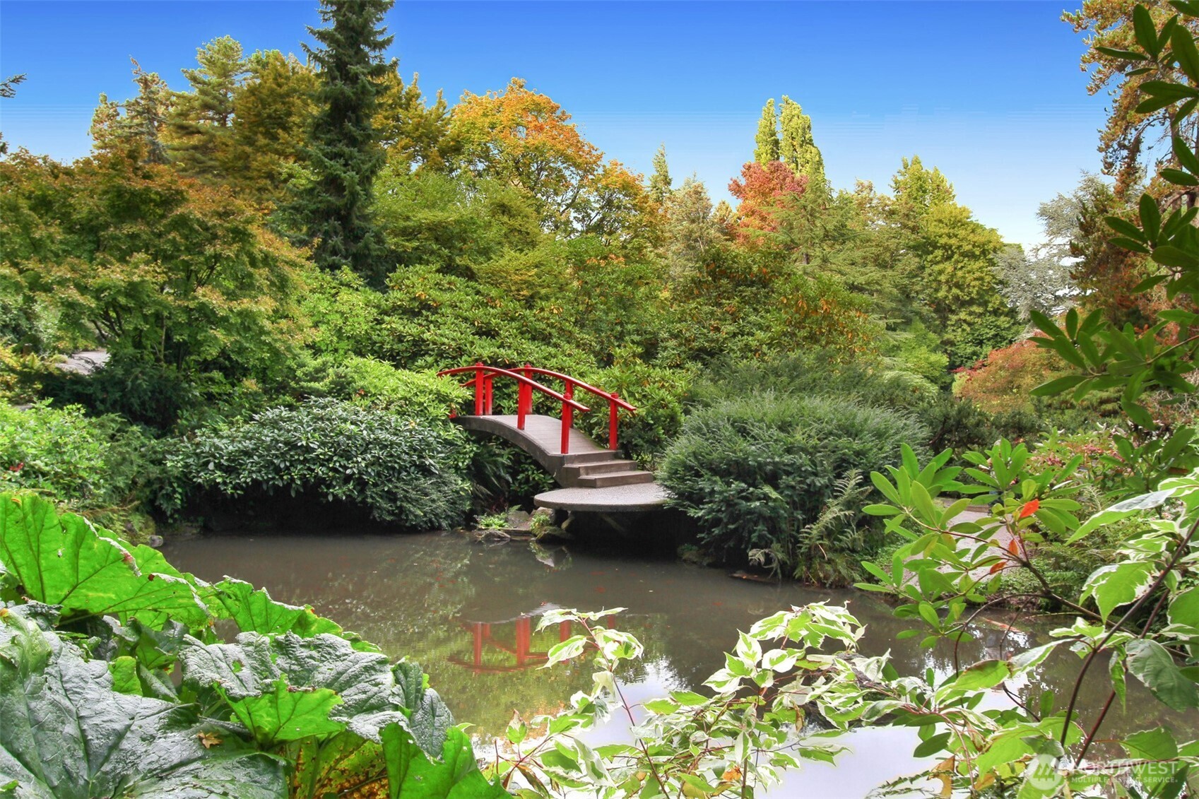5126 South Garden Loop Road, Unit 11 Seattle, WA 98118 - Photo 32 of 36 a view of a lake with a house in the background