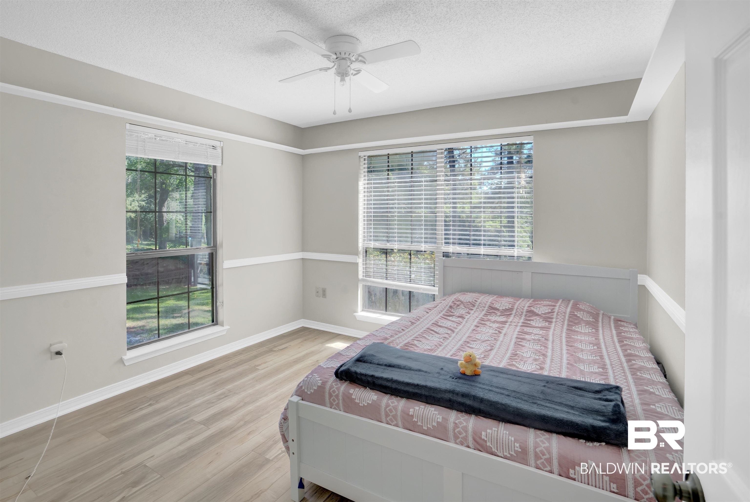 30871 Stanton Road Spanish Fort, AL 36527 - Photo 21 of 35 Bedroom featuring ceiling fan, light hardwood / wood-style floors, and a textured ceiling