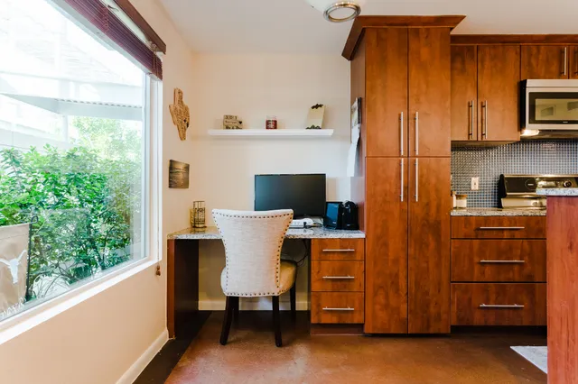 a view of a dining room with furniture and a window