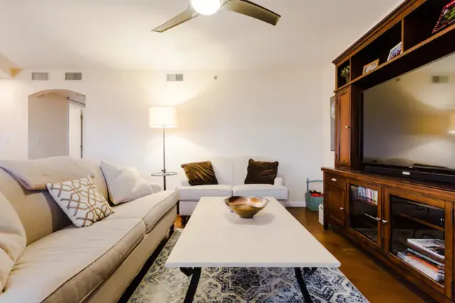 a living room with furniture and a flat screen tv
