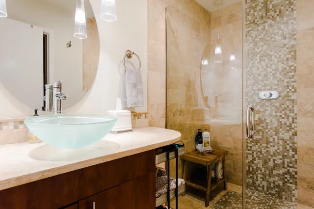 a bathroom with a sink a toilet and shower