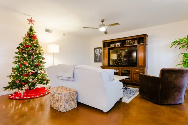 a living room with furniture and a flat screen tv