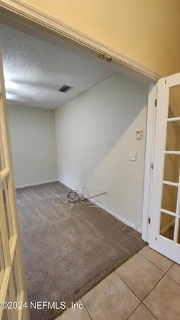 a view of an empty room with windows