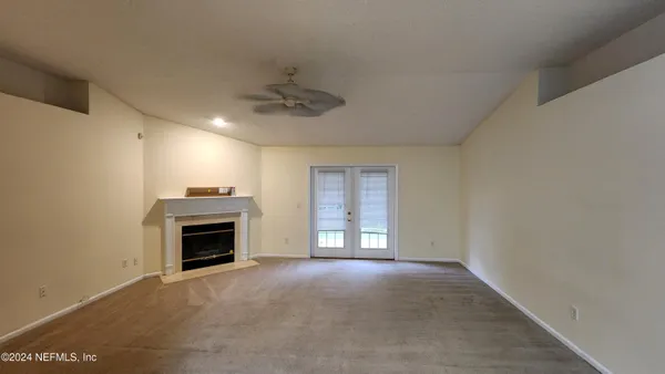 a view of empty room with a fireplace