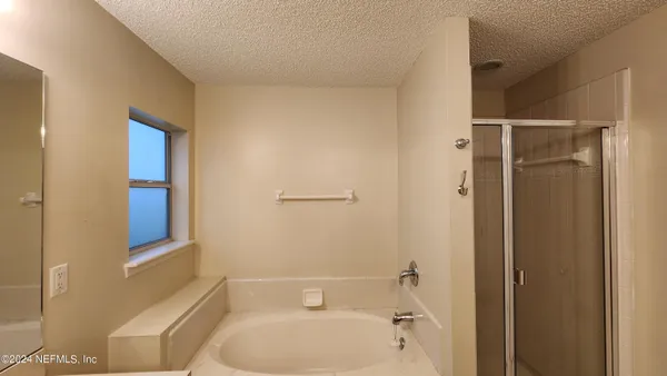 an empty room with a ceiling fan and a window